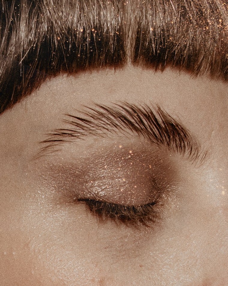 Editorial eye look with glitter across the lid