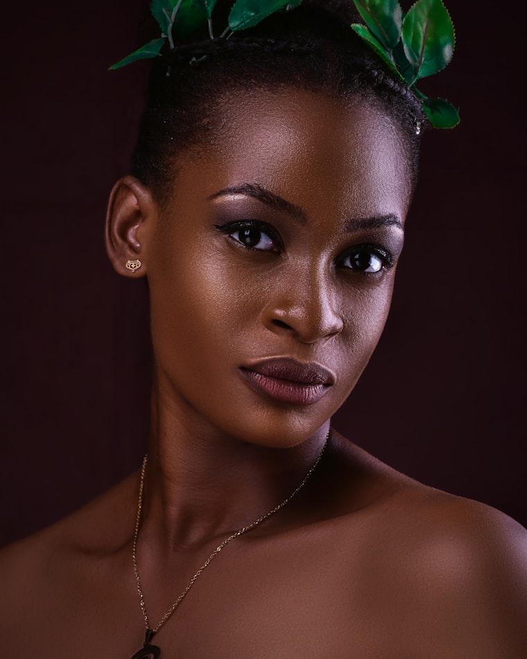 Fresh natural makeup styled with green leaves in the hair