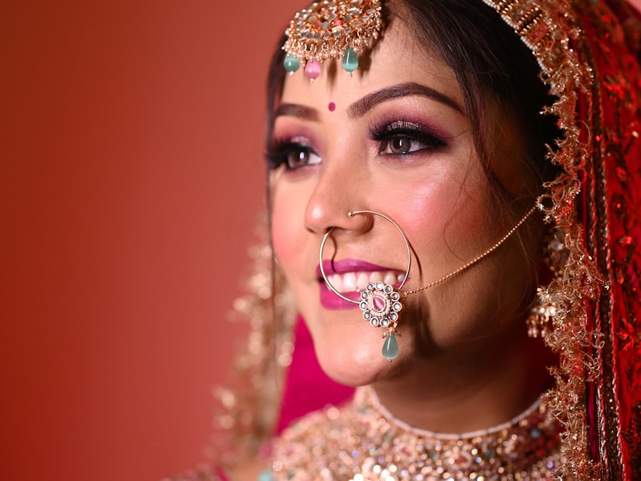 Bride in red and gold with detailed bridal makeup