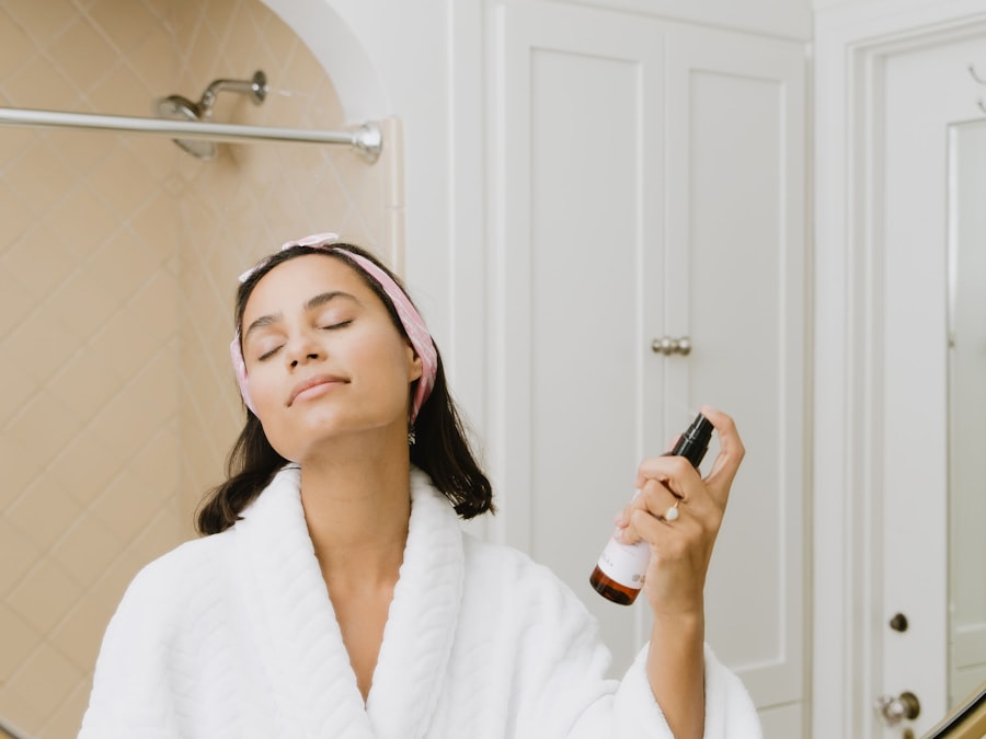 Client in a robe having a facial mist applied